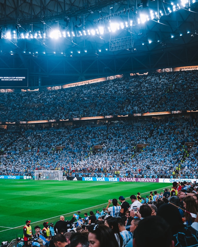 A photo of football fans in the stand watching their team play during a World Cup match.